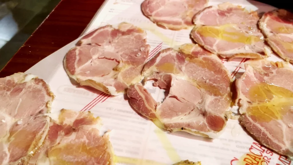 slices of pork loin and olive oil and sea salt Casa Lola restaurant in Malaga Spain
