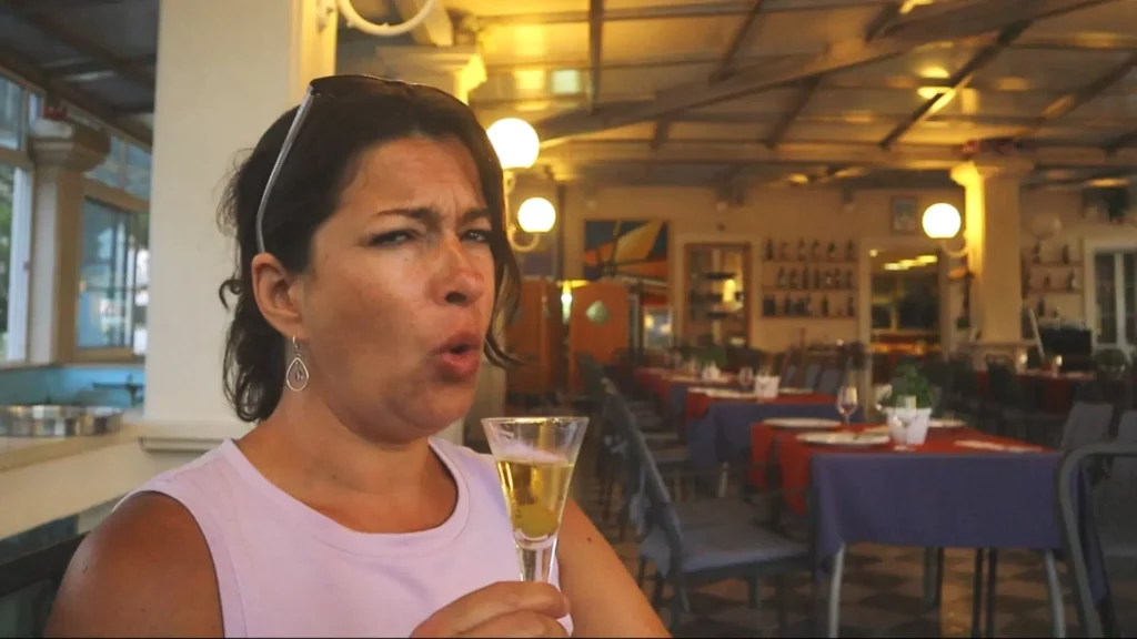 Angela drinking very strong Rakija at Vila Karuna Restaurant in Mali Ston Croatia