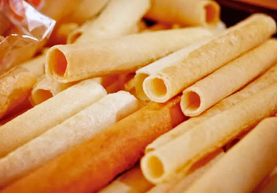 Barquillos, a classic Bacolod sweet, featuring thin, crispy wafer rolls made from flour, sugar, and eggs.