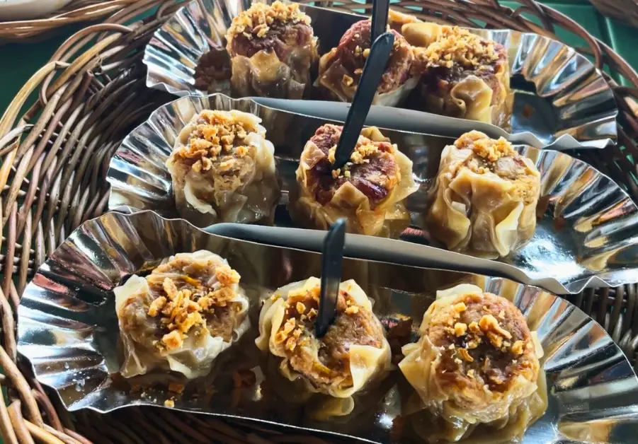 Close-up of rabbit siomai topped with crispy garlic, served at Hops Grill House.