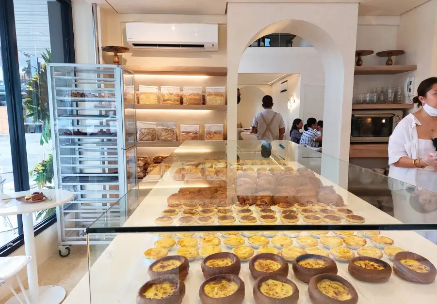 Inside Gorda bakery, showcasing freshly baked egg tarts and artisanal bread.