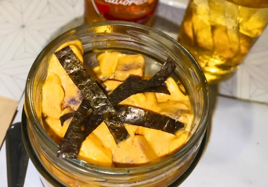 Mango kinilaw served in a mason jar with seaweed strips and side drink at Rekado