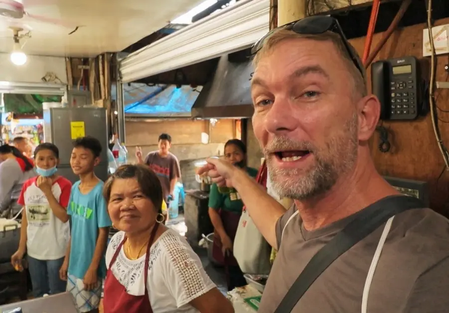 Geoff with the owner of Paz Eatery inside the stall at Bankerohan Market in Davao