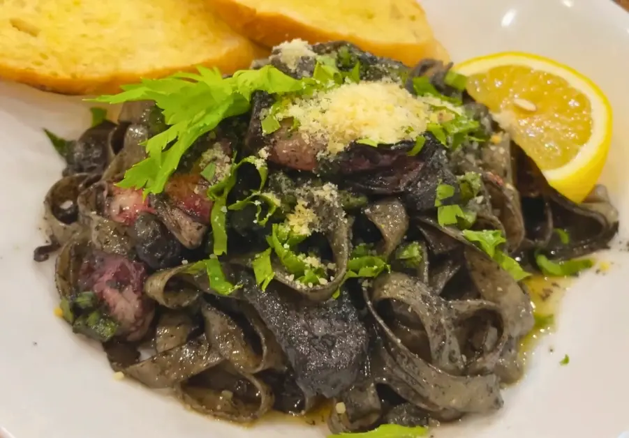 Where to Eat in Quezon City: 11 Must-Try Locations Squid ink pasta negra with garlic bread at Art Circle Cafe near UP Diliman.