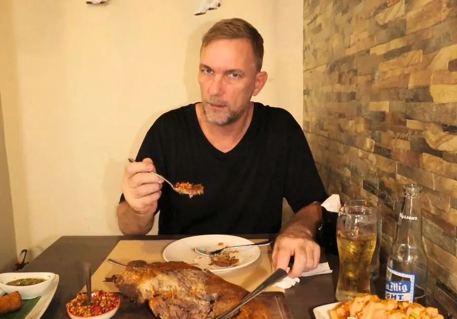 Geoff enjoying crispy pata at Livestock Restaurant Bar in Quezon City