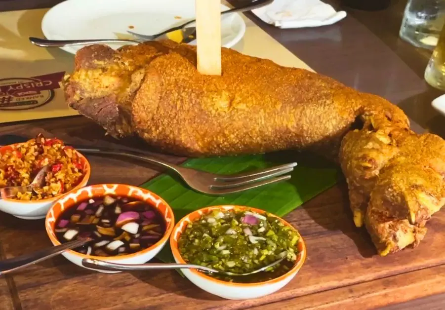 Full serving of nuked crispy pata with dipping sauces at Livestock QC