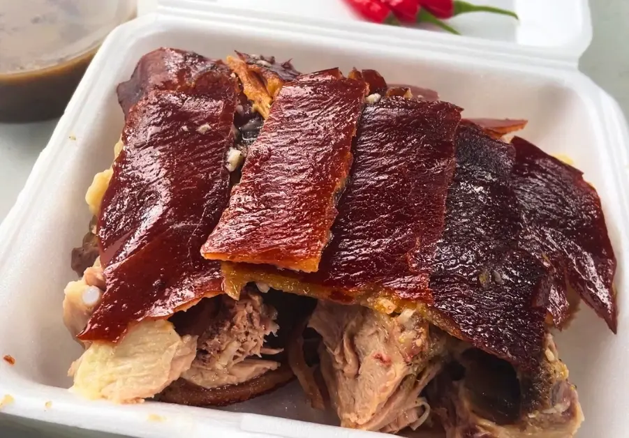 Where to Eat in Quezon City: 11 Must-Try Locations Takeout lechon with extra crispy skin from Mang Tomas Native Lechon in Quezon City.