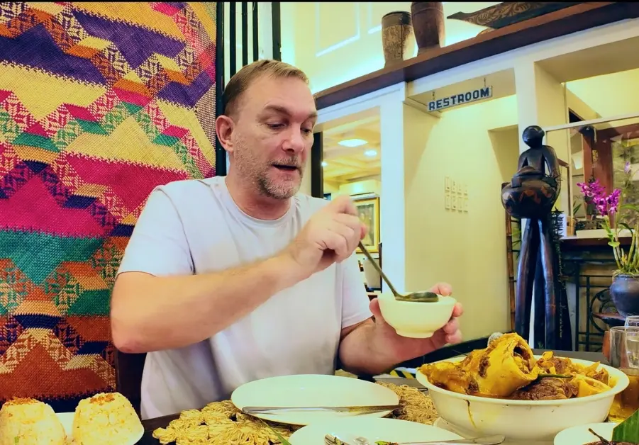 Geoff eating kansi at Provenciano Restaurant in Quezon City
