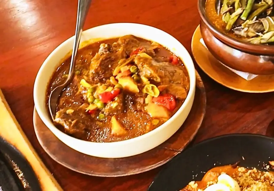 Spicy beef kaldereta from Little Quiapo with bone-in chunks and vegetables in tomato-based sauce