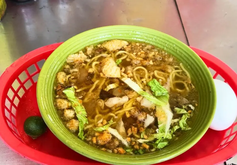 Filipino Street Food: Random Streets in Bago Bantay Bowl of batchoy with pork liver, noodles, and chili oil from a Filipino street food stall