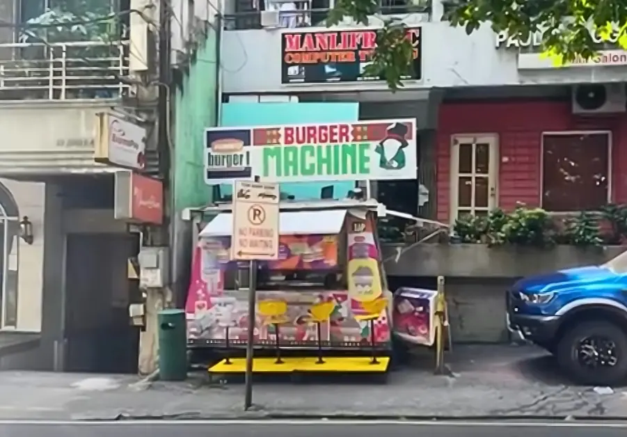 Cheap Eats in Quezon City: Affordable Restaurants and Meals Roadside Burger Machine stand in Quezon City with stools and a no parking sign out front