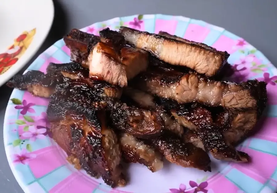 Morning Sun Eatery: The Carinderia You Didn’t Know You Needed Close-up of grilled liempo on a floral plate at Morning Sun Eatery