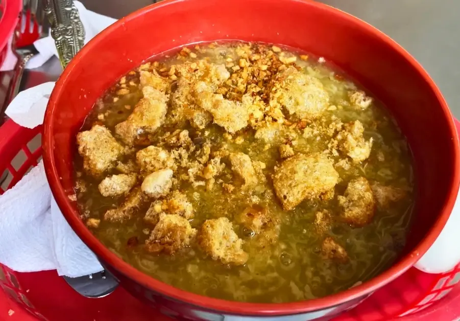 Cheap Eats in Quezon City: Affordable Restaurants and Meals Close-up of hot lugaw served in a plastic bowl at Palma’s Lugawan in Quezon City.