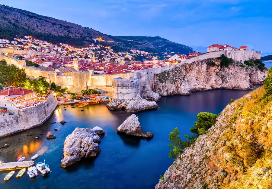 Old city walls and harbor of Dubrovnik, Croatia at dusk
