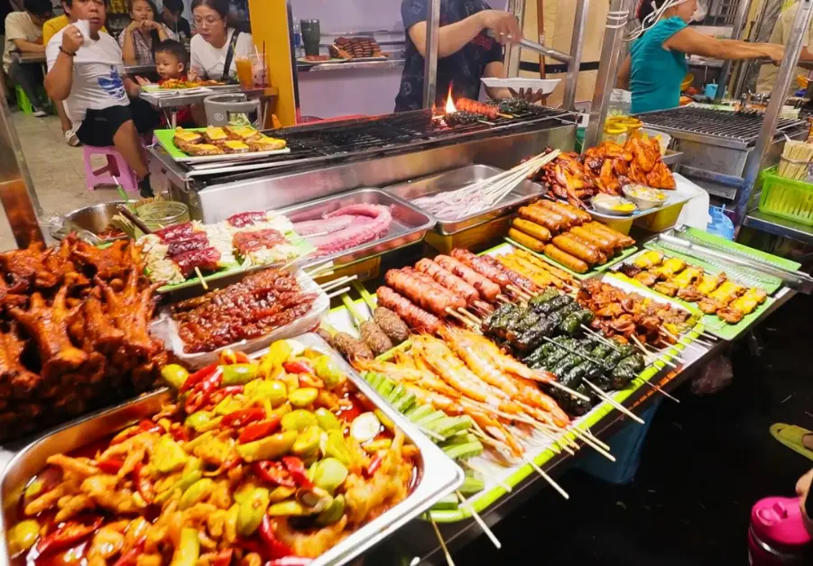 Massive grilled meat stall at Hồ Thị Kỷ Night Market, one of the most popular street food spots in Saigon. Vietnamese BBQ, Cambodian skewers, chicken feet, and every part of the animal you didn’t know people actually eat.