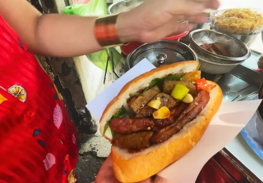 Bánh mì sausage loaded with garlic, pickled vegetables, and grilled pork in Saigon