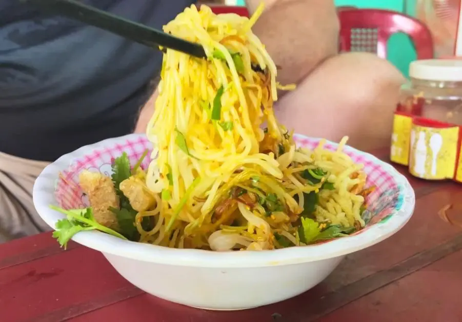 Bowl of bún hến with baby clams, noodles, and herbs in Hue