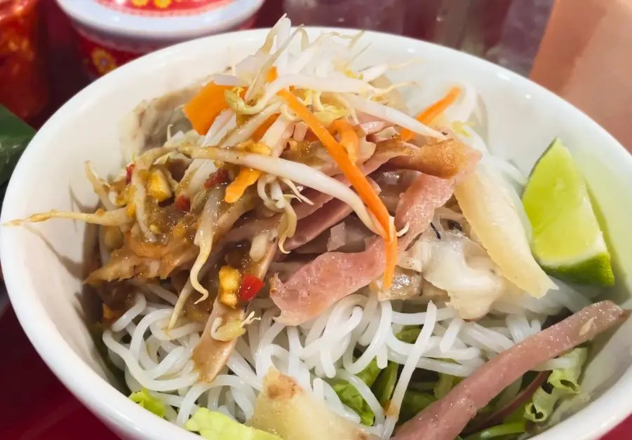 Bowl of bún mắm nêm with rice noodles, pork, and anchovy sauce