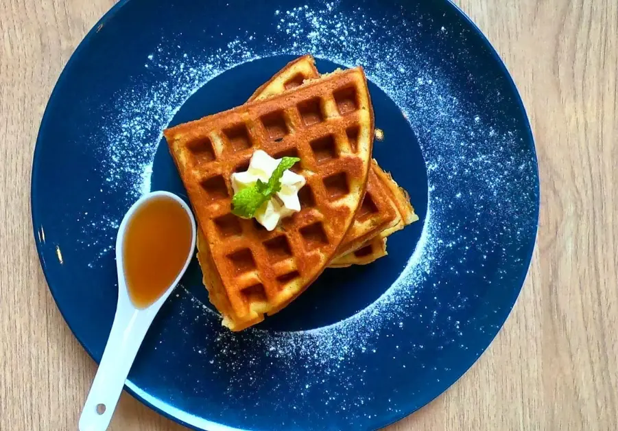 Golden waffles with syrup and butter served at Kanto Freestyle Breakfast