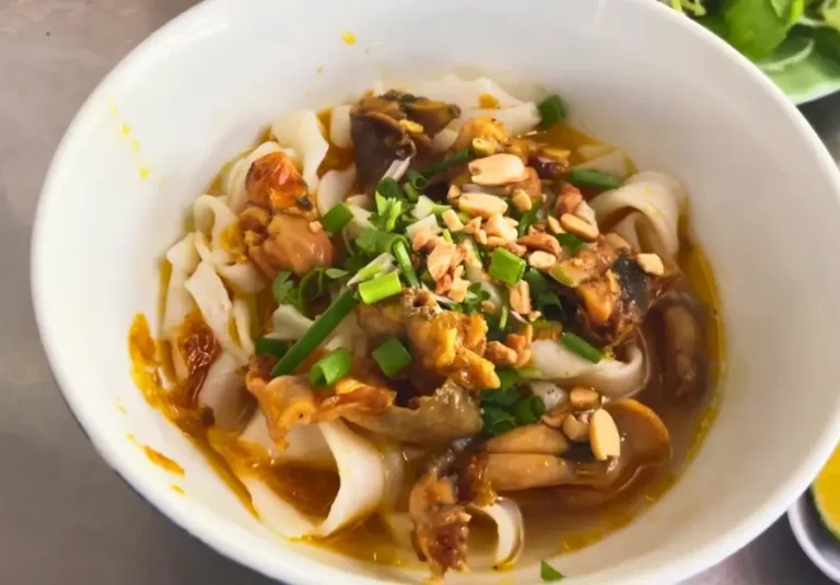 Mì quảng noodles with frog, peanuts, and herbs served at a local restaurant in Danang