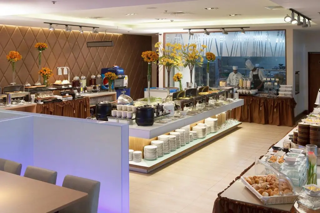 Goto Believe: Kapitolyo's Mind-Blowing Congee Breakfast buffet spread with pastries, hot dishes, and live cooking station at Ace Hotel and Suites in Pasig.