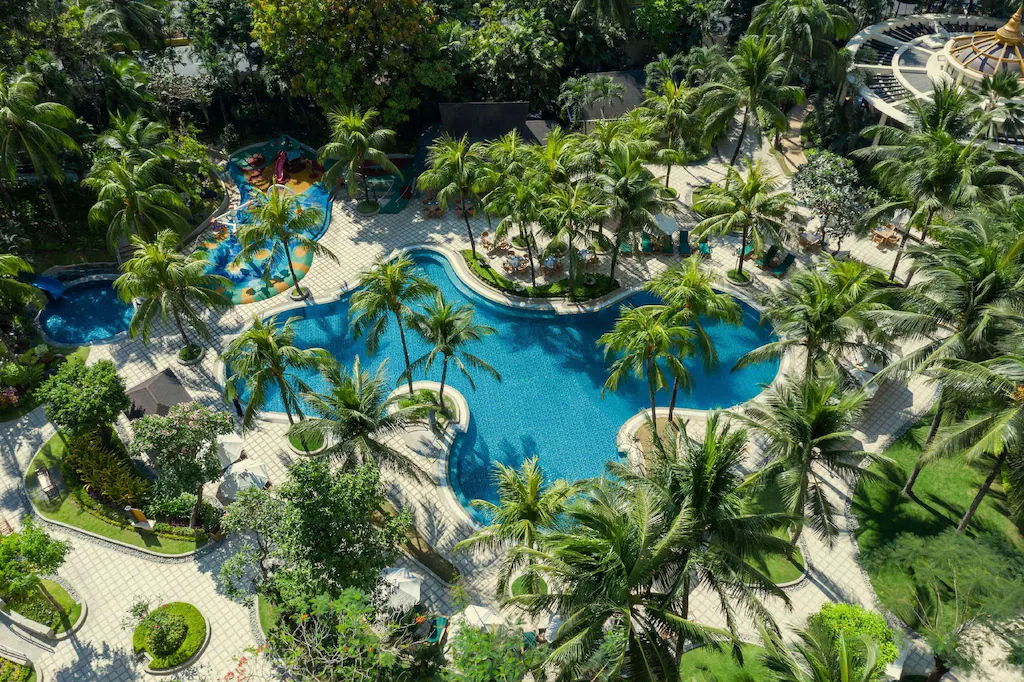Goto Believe: Kapitolyo's Mind-Blowing Congee Aerial view of the tropical lagoon-style swimming pool surrounded by palm trees at Edsa Shangri-La Manila in Ortigas.