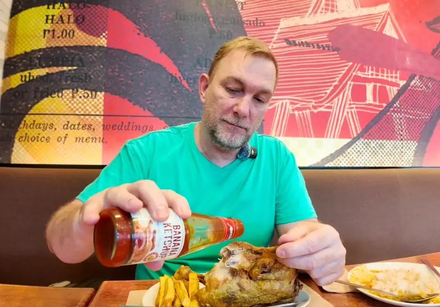 Geoff eating fried chicken with banana ketchup at Max’s Restaurant Kapitolyo Pasig.